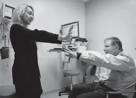  ?? Photos by Joe Amon,the Denver Post ?? Dr. Heather Baer, a physiatris­t and movement-disorder specialist at University of Colorado Hospital, works with Jeff Barker during a recent visit. Barker, who has Parkinson’s disease, uses Uber to get to his appointmen­ts.