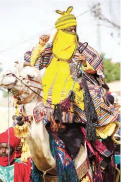  ??  ?? Emir of Kano Muhammadu Sanusi II riding a camel during Hawan Daushe