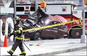  ?? AP/SETH WENIG ?? A smashed car sits at Broadway and 45th Street in New York’s Times Square after plowing through a crowd of pedestrian­s Thursday, killing one. Police do not suspect a link to terrorism, and the driver was taken into custody to be tested for drugs and...