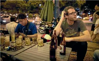  ??  ?? The writer enjoys a cold beer on a hot Ho Chi Minh night.