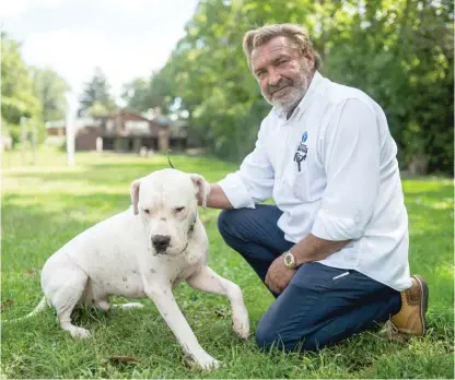  ?? PAT NABONG/SUN-TIMES FILE ?? Joe Petit with his dog, Philotimo, in his backyard in west suburban Wayne. Petit said his neighbor, Hal Phipps, had no justificat­ion for shooting Petit’s other dog, Ludwig, on Aug. 10. Authoritie­s decided otherwise this week.