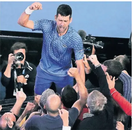  ?? FOTO: NG HAN GUAN/AP ?? Novak Djokovic kletterte nach dem Sieg auf die Tribüne und feierte mit seinem Team und seiner Familie den Rekord. Die Erleichter­ung über den Triumph war ihm deutlich anzumerken.