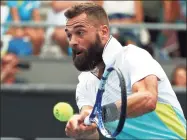  ?? Dita Alangkara / Associated Press ?? France’s Benoit Paire makes a backhand return to Croatia’s Marin Cilic during their second round singles match in January at the Australian Open in Melbourne, Australia. Paire has tested positive for the coronaviru­s and was removed from the U.S. Open field, a person familiar with the situation told The Associated Press on Sunday.