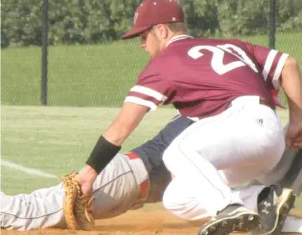  ?? (Photo by Danny P. Smith, SDN) ?? East Webster first baseman Spencer Carden (20) reaches down for a tag on a pickoff attempt during Friday's game against Baldwyn.
