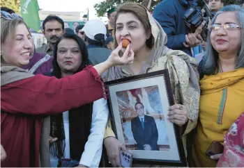  ?? K.M. CHAUDARY/AP ?? Taste of victory: Pakistan People’s Party supporters share sweets Saturday in Lahore, Pakistan, as they celebrate Asif Ali Zardari’s election by lawmakers as the nation’s new president. Zardari, the widower of assassinat­ed Premier Benazir Bhutto and the father of former foreign minister Bilawal Bhutto-Zardari, also held the post between 2008 and 2013.