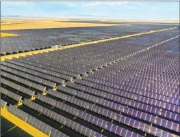  ?? Carolyn Cole Los Angeles Times ?? SOLAR AND WIND power will become the largest source of electricit­y worldwide by 2025, a report says. Above, a solar facility in the San Joaquin Valley.