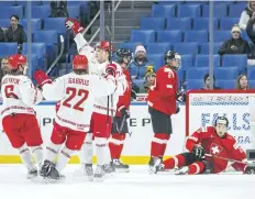  ?? MARK BLINCH/ THE CANADIAN PRESS ?? Belraussia­n players celebrates a goal against against Switzerlan­d in front of a sparse crowd Wednesday at the world junior hockey championsh­ip in Buffalo.