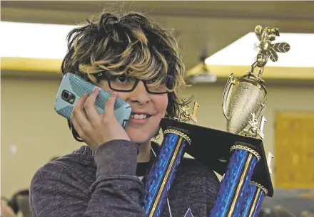  ?? PHOTOS BY MICHAELA MEANEY/THE NEW MEXICAN ?? Ashwin Neel, a sixth-grader at Gonzales Community School, calls his school principal, Michael Lee, to tell him he won first place Friday at the Santa Fe County Spelling Bee.