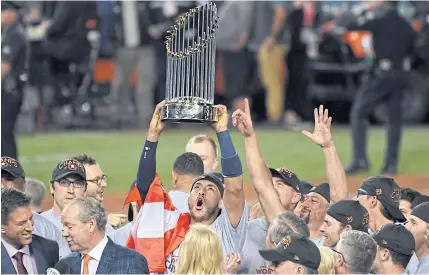  ?? USA TODAY SPORTS ?? Astros centre fielder George Springer celebrates with the Commission­er’s Trophy at Dodger Stadium.