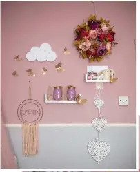  ??  ?? Alimah loves crafting, especially for her children’s rooms. She made the faux floral wreath for a whimsical touch. ‘I customised the jars with pink and gold paint to house cotton buds and hair bands, too,’ she says