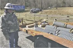  ?? BY JOHN MCCASLIN ?? A lineman from Akron, Ohio explains how replacemen­t insulators will be flown by helicopter to remote power poles in Thornton Gap. "When one breaks it’s like a chain reaction — they all snap off,” he said.