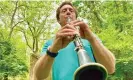  ?? Photograph: Kevin Fogarty/Reuters ?? More-than-human … David Rothenberg plays the clarinet alongside the sounds of cicadas at a New Jersey nature preserve.