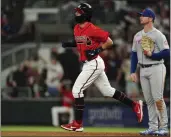  ?? JOHN BAZEMORE — THE ASSOCIATED PRESS ?? Atlanta Braves’ Dansby Swanson runs past New York Mets first baseman Pete Alonso (20) after hitting a solo home run during the sixth inning Friday in Atlanta.