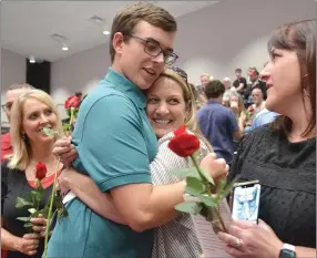  ?? Annette Beard/Pea Ridge TIMES ?? PRHS senior Connor Gartrell presented flowers and hugs to his mother, Traci Gartrell (far left), Gina Easterling (center) and Betsy Heckman (far right) during baccalaure­ate Friday, May 12.