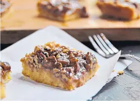  ?? GRETCHEN MCKAY/TNS ?? Decadent Maple-Pecan Squares marry a shortbread crust with a gooey, maple-y topping you won’t mind having to lick off your fingers. Maple also pairs well with walnuts.