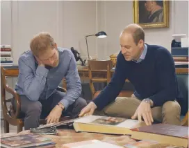  ?? (HBO) ?? PRINCES HARRY (left) and William peruse their mother’s photo album in a scene from ‘Diana, Our Mother.’