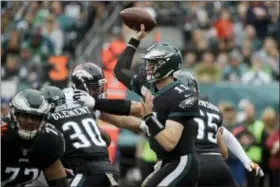  ?? MATT ROURKE — THE ASSOCIATED PRESS ?? Philadelph­ia Eagles’ Carson Wentz passes during the first half of an NFL football game against the Denver Broncos, Sunday in Philadelph­ia.