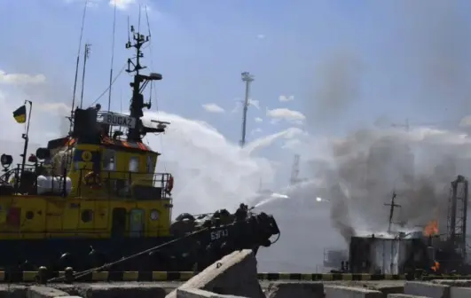  ?? Odesa City Hall, via The Associated Press ?? Firefighte­rs put out a fire in the Port of Odesa on Saturday. Russian missile strikes on the Ukrainian port came less than 24 hours after a deal was signed to secure the transit of millions of tons of grain through Black Sea routes.