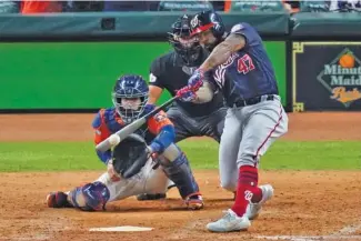  ?? AP FILE PHOTO/ERIC GAY ?? The Washington Nationals’ Howie Kendrick hits a two-run home run against the Houston Astros during the seventh inning of Game 7 of the World Series in Houston.