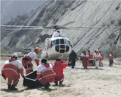  ?? AP ?? Iranian Red Crescent workers yesterday carry the bodies of victims of the Sunday’s plane crash in Shahr-e Kord, south-west Iran. Turkish socialite and bride-to-be Mina Basaran, left, her party of friends and the aircraft’s crew all perished in the crash