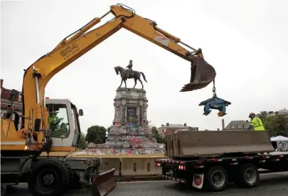  ?? Photograph: Julia Rendleman/Reuters ?? Crews work to add barriers around the Robert E Lee monument in Richmond, Virginia.