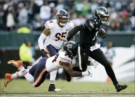  ?? MATT ROURKE - T HE ASSOCIATED PRESS ?? The Philadelph­ia Eagles’ Carson Wentz, right, is tackled by Chicago Bears’ Leonard Floyd during the second half of an NFL game, Sunday, in Philadelph­ia.