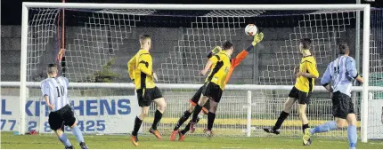  ??  ?? Holyhead Town’s No 10, Tom Hadley, smashes home another goal