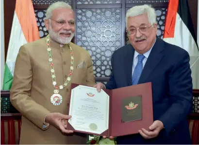  ?? PTI ?? Prime Minister Narendra Modi receives the Grand Collar — the highest order given to foreign dignitarie­s — from Palestinia­n President Mahmoud Abbas after the conclusion of their bilateral meeting in Ramallah on Saturday.—