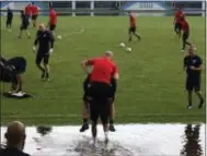  ?? RON BLUM — THE ASSOCIATED PRESS ?? U.S. national soccer team captain Michael Bradley is carried through water around the practice field during training in Couva, Trinidad, Monday. Team USA plays against Trinidad & Tobago on Tuesday.