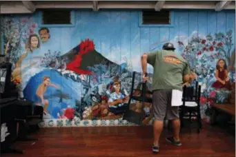  ?? JAE C. HONG - THE ASSOCIATED PRESS ?? Restaurant worker William Kauhane, 20, moves chairs at Lava Rock Cafe in Volcano, Hawaii Thursday, May 10, 2018. The village is located on the border of Hawaii Volcanoes National Park, just a few miles east of Kilauea’s summit crater.