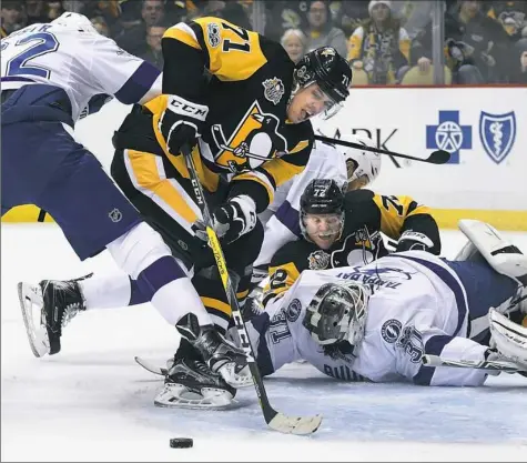  ?? Peter Diana/Post-Gazette photos ?? Tampa Bay Lightning goalie Peter Budaj makes save on center Evgeni Malkin in the first period Friday at PPG Paints Arena.