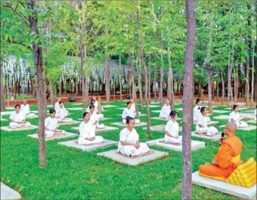  ?? TUY SOKHIM ?? Buddhists meditate at Wat Soryaram in Battambang province’s Moung Russey district (left).