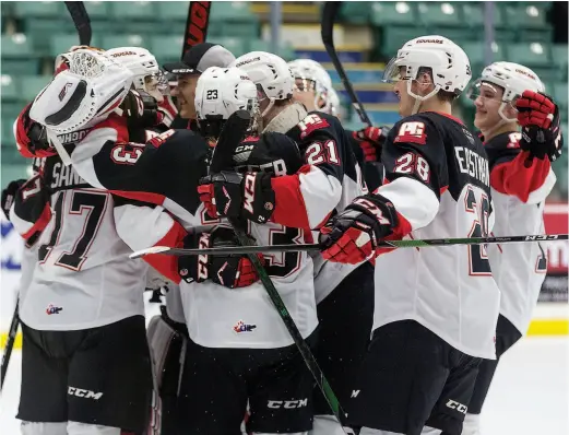  ?? CITIZEN PHOTO BY JAMES DOYLE ?? Taylor Gauthier is mobbed by his teammates in March at CN Centre as the Prince George Cougars shut out the Lethbridge Hurricanes by a score of 2-0.