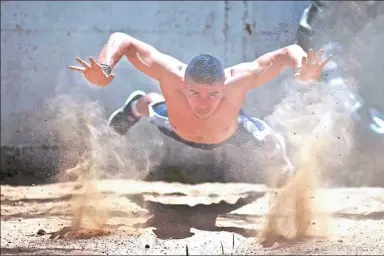  ?? MOHAMMED SALEM / REUTERS ?? Palestinia­n Mohammed al-Hoor, 23, demonstrat­es his workout skills at the Nuseirat refugee camp in the Gaza Strip on Tuesday.