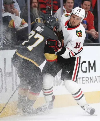  ?? | JOHNLOCHER/ AP ?? Hawks center Artem Anisimov ( right) checks Golden Knights defenseman Brad Hunt into the boards Tuesday night.