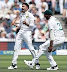  ?? ?? SOUTH Africa’s Keshav Maharaj celebrates with Lungi Ngidi after taking the wicket of England’s Ollie Pope. | PETER CZIBORRA Reuters