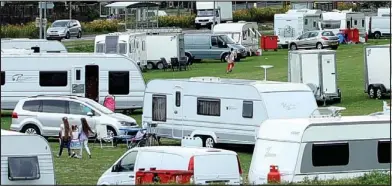  ??  ?? Prime land: Travellers set up 30 caravans in Wild Park last week after Brighton council let them in