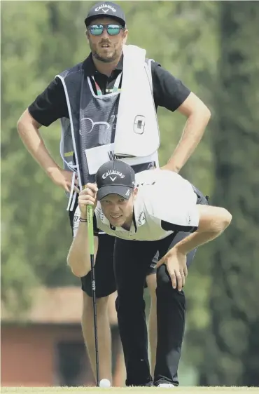  ??  ?? 0 Danny Willett and caddie Sam Haywood line up a putt during day one of the Italian Open in Brescia.