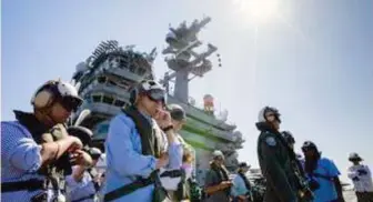  ??  ?? A U.S. Embassy photo released to the regional newspaper Mindanao Examiner shows Filipino and American officials watching flight operations from the deck of the aircraft carrier USS Carl Vinson. The Carl Vinson is operating in the Indo-pacific region to conduct routine maritime operations, promote freedom of navigation, and work with partners and allies to enhance regional security and stability.