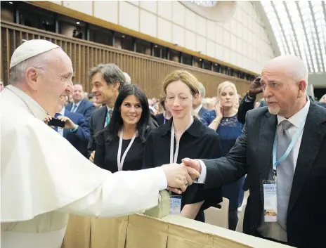  ?? AFP/GETTY IMAGES ?? Peter Gabriel shakes hands with Pope Francis as the singer’s wife Meabh Flynn, centre, looks on during Unite To Cure, A Global Health Care Initiative, at the Vatican. Flynn had a form of non-Hodgkin’s lymphoma, which has since been cleared thanks to a...