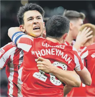  ??  ?? Luke O’Nien and George Honeyman celebrate the latter’s goal.