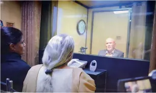  ?? PTI ?? Indian spy Kulbhushan Jadhav’s wife and mother meet him while seated across a glass partition at the Foreign Office in Islamabad on Monday. —