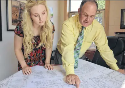  ?? MILLICENT MCKAY/JOURNAL PIONEER ?? Georgia Gunn, left, a Grade 12 student at Three Oaks Senior High, and principal Jeff Clow look at the plans for the school’s new black box theatre.