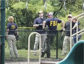  ?? Jacquelyn Martin Associated Press ?? FBI AGENTS survey a playground Thursday near the baseball field in Alexandria, Va., where a gunman opened fire on Republican­s who were practicing.