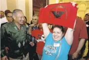  ?? RICH PEDRONCELL­I/ASSOCIATED PRESS ?? Maria Ceja, right, joins other farmworker­s in celebratin­g outside the Assembly chambers after overtime victory.