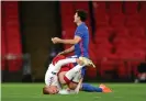  ??  ?? Kasper Dolberg rolls away in pain after the challenge that resulted in Harry Maguire’s second yellow card. Photograph: Daniel Leal Olivas/PA