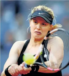  ?? CLIVE ROSE/GETTY IMAGES ?? Eugenie Bouchard hits a shot Wednesday during her victory over Angelique Kerber at the Madrid Open in Madrid, Spain. Bouchard was leading 6-3, 5-0 when Kerber retired with a thigh injury.