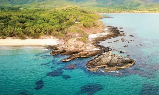  ??  ?? Thala Beach Nature Reserve ... the resort is set on a rocky headland (above); relax in a hammock under a shady tree, or indulge in good food (opposite page).