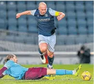  ??  ?? Dundee’s Charlie Adam skips over a tackle