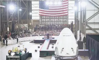  ?? — AFP photo ?? Donald Trump speaks near a SpaceX Crew Dragon capsule at a press briefing after the launch of the SpaceX Falcon 9 rocket and Crew Dragon spacecraft on NASA’s SpaceX Demo-2 mission to the Internatio­nal Space Station from NASA’s Kennedy Space Center in Cape Canaveral, Florida.